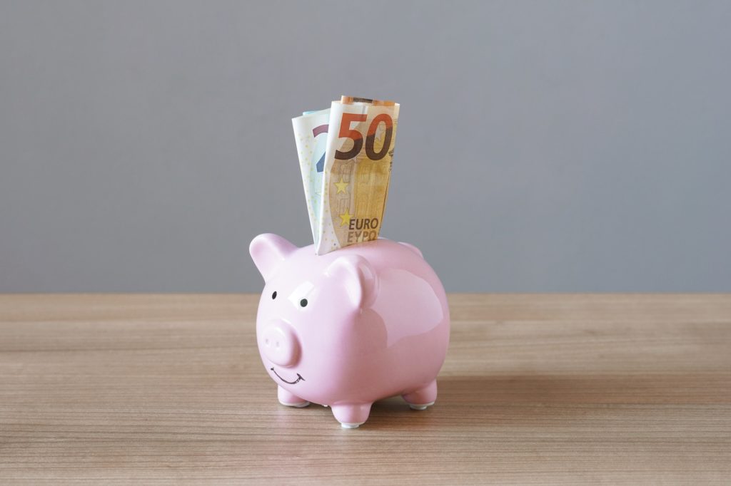 piggy bank or money box with euro banknotes as savings concept