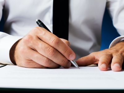 Businessman signing document